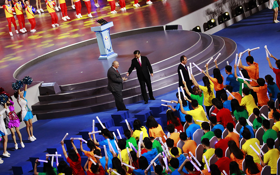 FIBA President Horacio Muratore, center left, and Chinese President Xi Jinping shake hands at the FIBA Basketball World Cup 2019 opening ceremony at the Beijing National Aquatics Center or Water Cube in Beijing, China, Friday, Aug. 30 2019. (How Hwee Young/Pool Photo via AP)