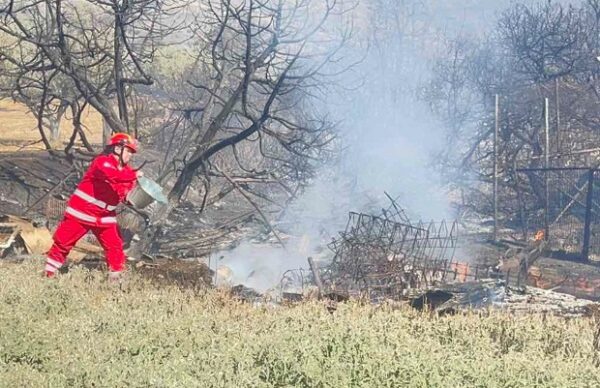 Εθελοντής Σαμαρείτης – Διασώστης του Ελληνικού Ερυθρού Σταυρού βοηθά στην κατάσβεση πυρκαγιάς στην Παλαιά Φώκαια.