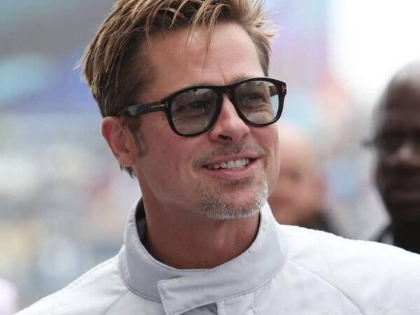 Ο Brad Pitt με γυαλιά ηλίου χαμογελάει, καθώς το νέο του φιλμ «F1» κατακτά την κορυφή του box office.