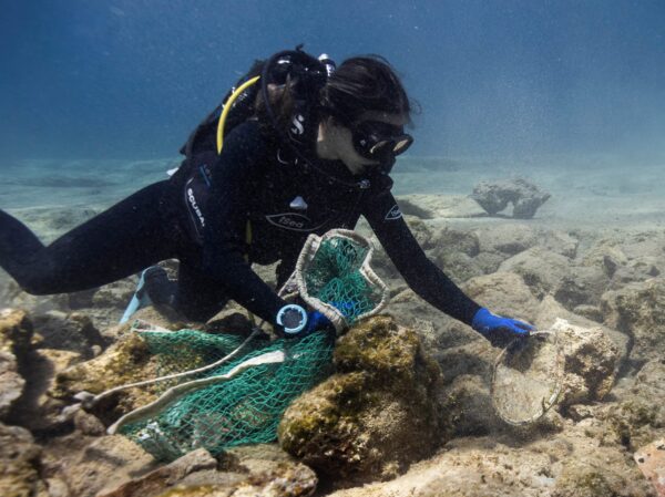 Δύτης της iSea καθαρίζει τον βυθό σε περιοχή Natura 2000, απομακρύνοντας δίχτυα και σκουπίδια.